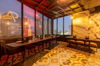 a restaurant with tables and chairs and a view of the city at Accent Park Opp Corporate Hub, 62 in Noida