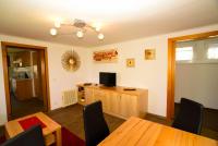 TV a/nebo společenská místnost v ubytování Apart of me Ferienhaus Faaker See