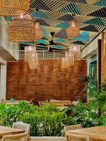 Un restaurante con mesas, sillas y lámparas de araña. en Stay Ceylon - Weligama, en Weligama