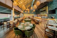 a restaurant with tables and chairs and a bar at Sheraton São Paulo WTC Hotel in Sao Paulo