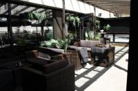 a patio with chairs and plants in a building at Original Sokos Hotel Koljonvirta in Iisalmi