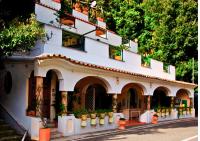 a building with potted plants on the side of it at Rays of sun - Positano in Positano