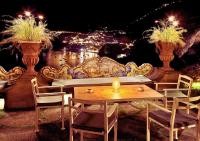 a table and chairs and a couch with lights at Rays of sun - Positano in Positano
