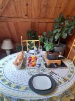 ein Tisch mit einem Teller Essen darauf in der Unterkunft Les jardins d'armance in Le Valdahon