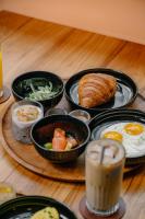 a table topped with bowls of breakfast foods and drinks at Sokkool Coliving and Coworking in Canggu