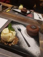 ein schwarzer Teller mit einem Dessert auf dem Tisch in der Unterkunft А17 Plovdiv Apartments - Close to University hospitals, Rowing Channel and Mall Plovdiv in Plowdiw