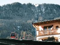 a ski lift in front of a building with a mountain at Hotel Kaiserhof Kitzbühel, 4 Sterne Superior in Kitzbühel