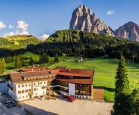 an aerial view of a hotel with mountains in the background at Monte Pana Dolomites Hotel in Santa Cristina in Val Gardena