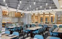 a restaurant with tables and chairs and a bar at Sheraton Kunming in Kunming