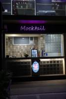 een restaurant met een paars uithangbord in het raam bij Hotel Pooja Garden, Nanded in Nanded