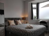 a bedroom with a bed with a pillow on it at Walton Suites in Watford