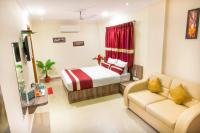a hotel room with a bed and a couch at Octave Hotel and Spa - JP Nagar in Bengaluru