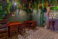 a restaurant with wooden tables and chairs in a room at Kava Suites Namchi in Namchi