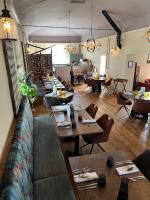 a restaurant with tables and chairs in a room at Colcombe Castle Hotel in Colyton