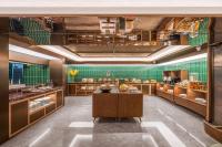 a large kitchen with green tiles on the walls at Orange Hotel Beijing Xi'erqi in Beijing