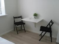 two chairs and a white table with a plant on it at Aalborg City Rooms ApS in Aalborg