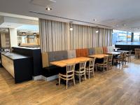 una fila de mesas y sillas en un restaurante en Hotel Ruby Foo's, en Montreal