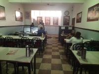 a restaurant with tables and people sitting at tables at HOTEL SATYA in Dehradun