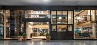 a store front with potted plants in front of it at Urban Hive Milano in Milan