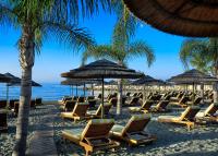 a bunch of chairs and umbrellas on a beach at Four Seasons Hotel in Limassol
