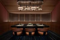 a dining room with a table and leather chairs at Marriott Executive Apartments Kuala Lumpur in Kuala Lumpur