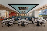 a restaurant with tables and chairs and a bar at Marriott Executive Apartments Kuala Lumpur in Kuala Lumpur