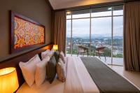 a bedroom with a bed and a large window at 360 Viewpoint by Queens Mount in Kandy