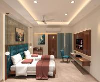 a bedroom with a bed and a desk and a television at Hotel K Fortune in Kurnool