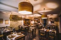 a restaurant with tables and chairs in a room at Locanda Vecchio Caseificio in Toano