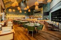 a restaurant with tables and chairs and a bar at Sheraton São Paulo WTC Hotel in Sao Paulo