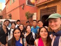 a group of people standing in front of a building at Kasbah Red Castel Hostel in Marrakech