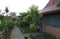 a house with a walkway next to a building at Nunu Bali Eco Friendly Retreat in Canggu