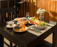 a black table with plates of food on it at Sala Hoi An Hotel in Hoi An