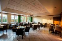 a dining room with tables and chairs and windows at Hotel Restaurant Körber in Osterwald Unterende