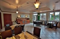 a dining room with tables and chairs in a restaurant at Hotel Restaurant Körber in Osterwald Unterende
