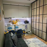 a living room with a table and a couch at Nova city center apartments in Tbilisi City