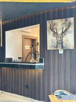 a mirror with a picture of a deer on a wall at Elysian Hotels Abuja in Abuja