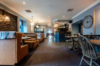 a restaurant with tables and chairs and a bar at Cardross Inn in Cardross