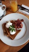 a white plate with toast with eggs and bacon at Cardross Inn in Cardross