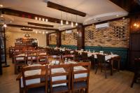 een eetkamer met houten tafels en stoelen bij Pensiunea Rami 