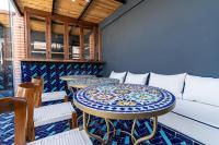 a room with two tables and a couch at Riad Serendip in Marrakech
