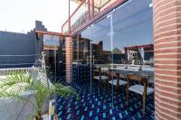a patio with tables and chairs on a roof at Riad Serendip in Marrakech