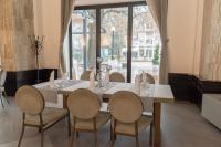 uma sala de jantar com mesa e cadeiras e uma janela em Zepterme Spa&Wellness Luxury Apartments member of Zepter hotels em Vrnjačka Banja