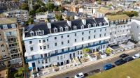 an overhead view of a large white building with blue accents at The Southcliff Hotel in Folkestone