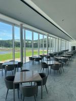 ein Esszimmer mit Tischen, Stühlen und Fenstern in der Unterkunft Uniisland The Spaville in Incheon