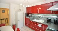 a kitchen with red cabinets and a white refrigerator at Appart&#39; Rachais in Lyon