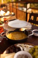 een tafel met een kom eten en borden eten bij Indra Village Hotel in Pazar