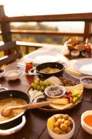 een tafel met veel borden eten erop bij Indra Village Hotel in Pazar