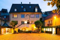 a large white building with a black roof at Hotel &amp; Spa A la cour d&#39;Alsace by HappyCulture in Obernai