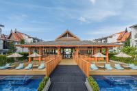 a pavilion with chairs and umbrellas next to a pool at Marriott Vacation Club, Khao Lak Beach Resort in Khao Lak